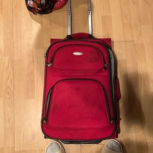 Red large suitcase. Red small suitcase. Black small suitcase